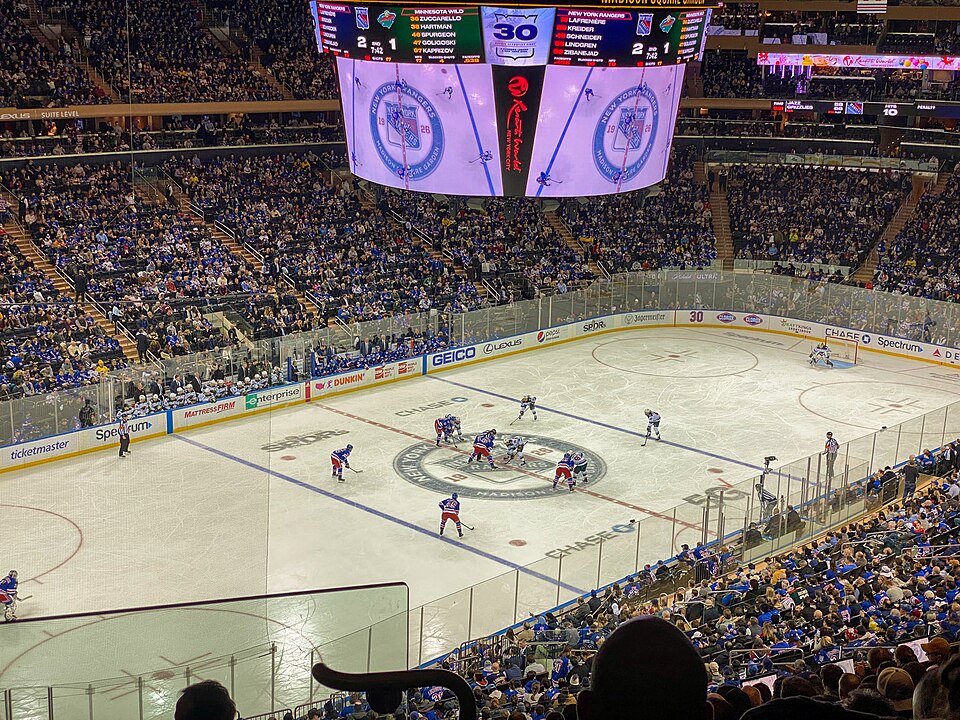 New York Rangers hockey game at Madison Square Garden with the rink, scoreboard, and crowd visible