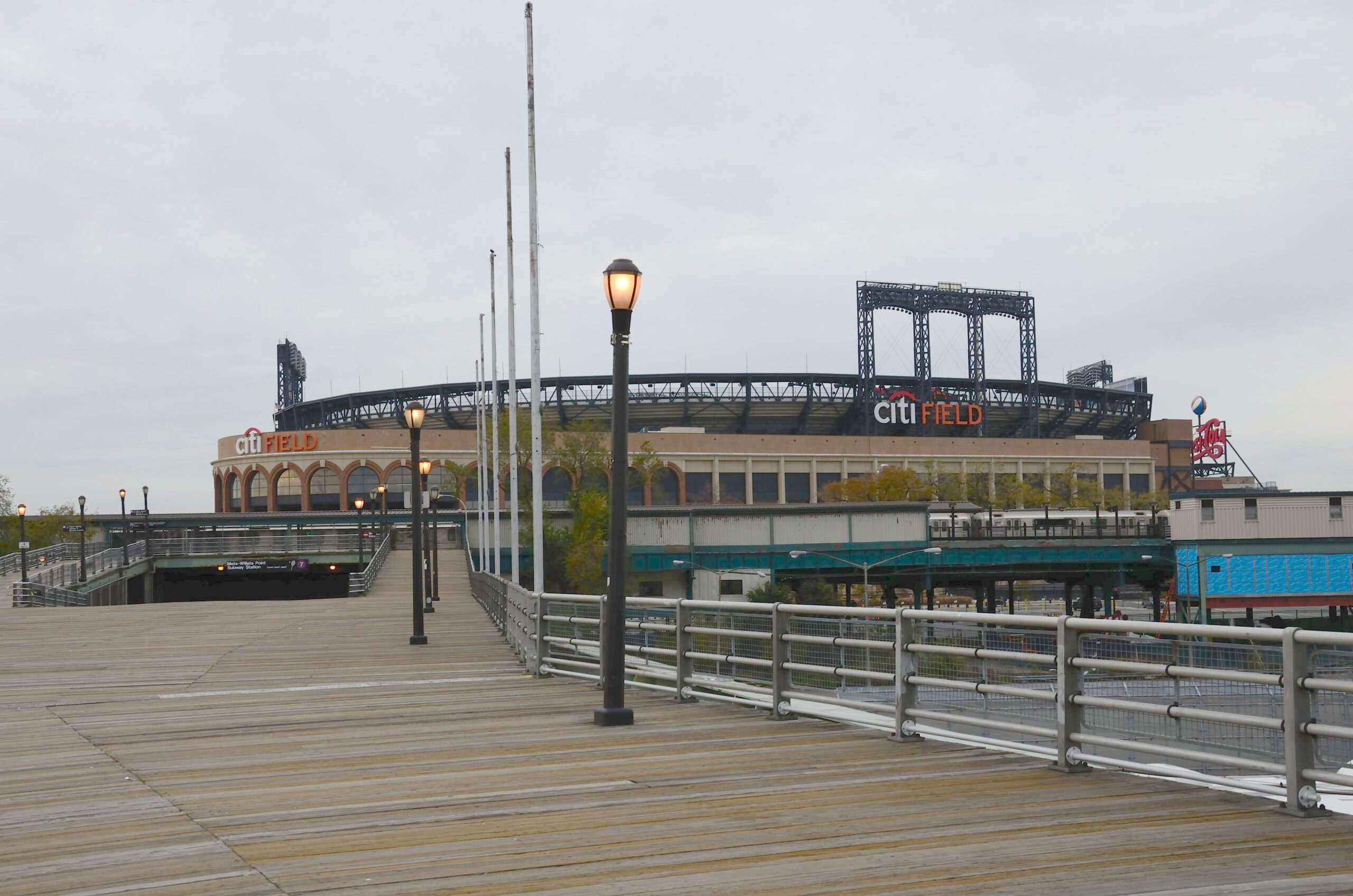 Mets-Willets Point station with train and Citi Field in Queens