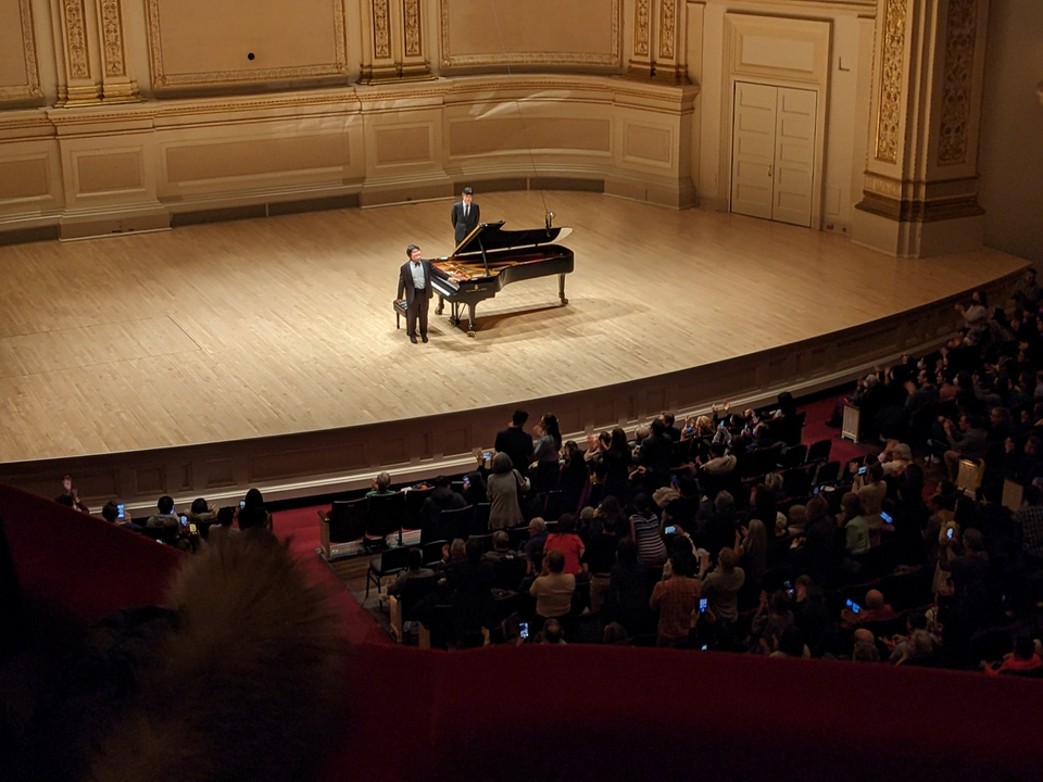 Pianist on stage at Carnegie Hall in New York City, capturing the elegant atmosphere of a live performance in one of the city’s most famous concert halls
