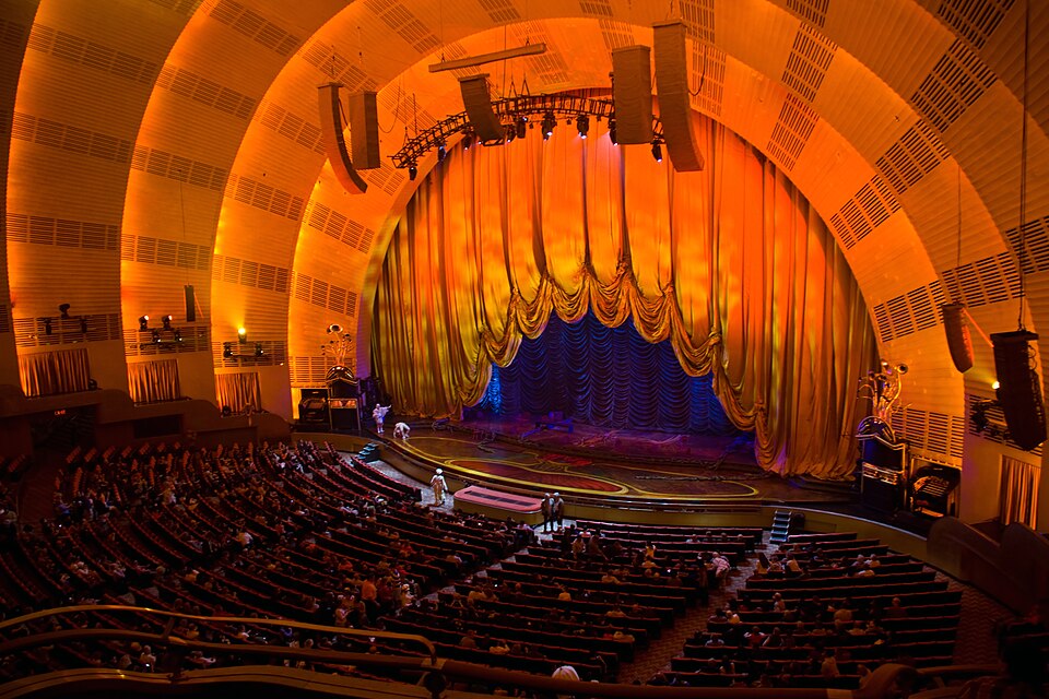 Interior stage view at Radio City Music Hall in New York City, showing the scale and atmosphere of a major live performance venue
