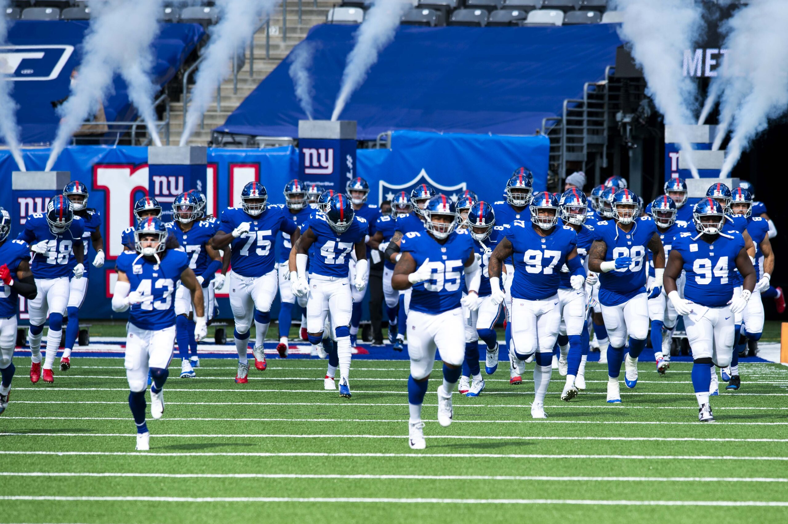 New York Giants players taking the field at MetLife Stadium