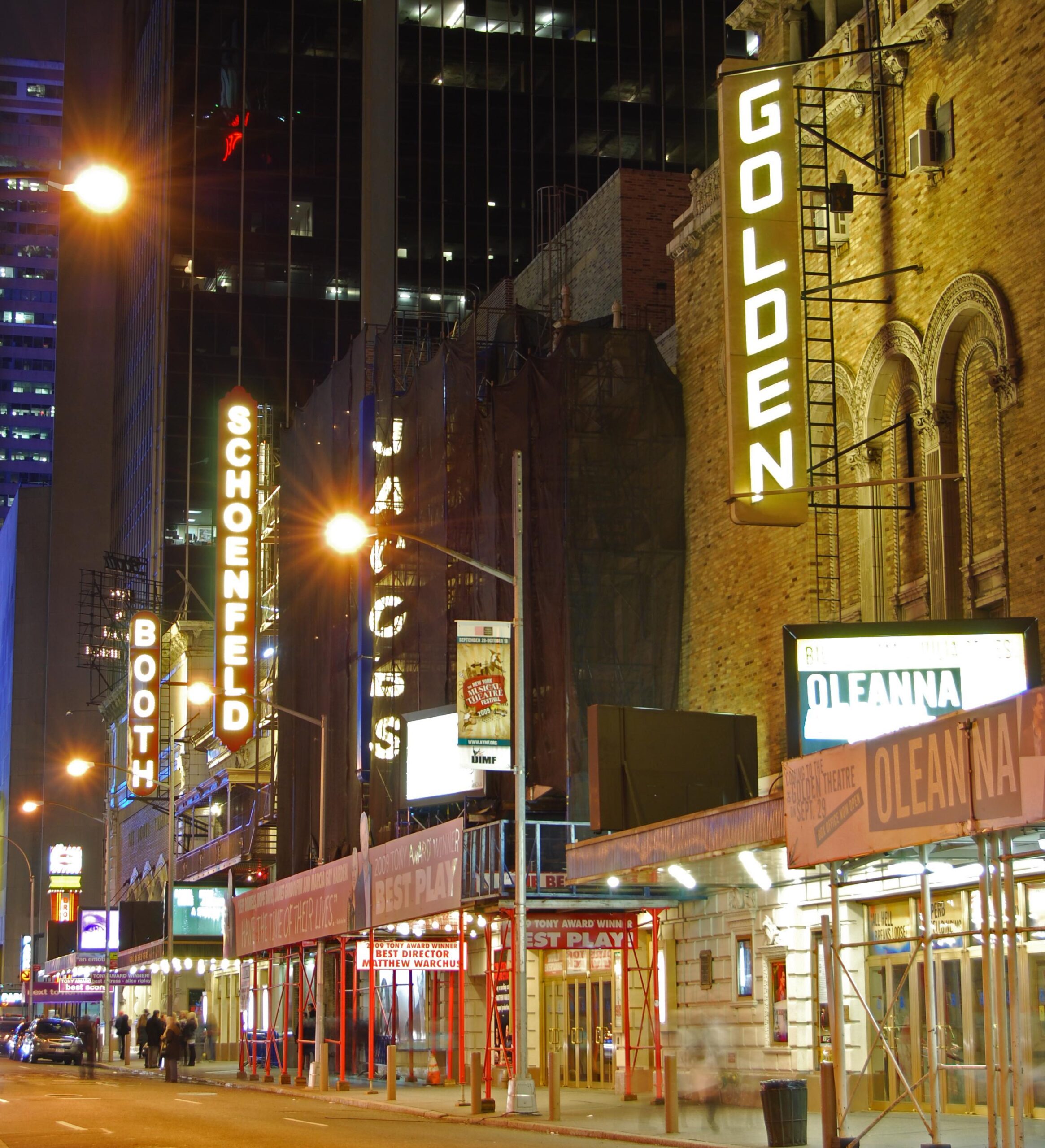 Broadway theaters lit up at night on West 45th Street in New York City, a romantic setting for a Broadway date night.