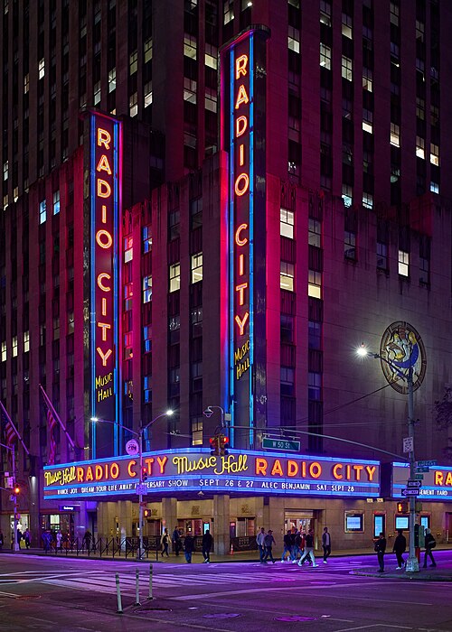 Radio City Music Hall lit up at night in Midtown Manhattan, a classic New York City concert date night setting.