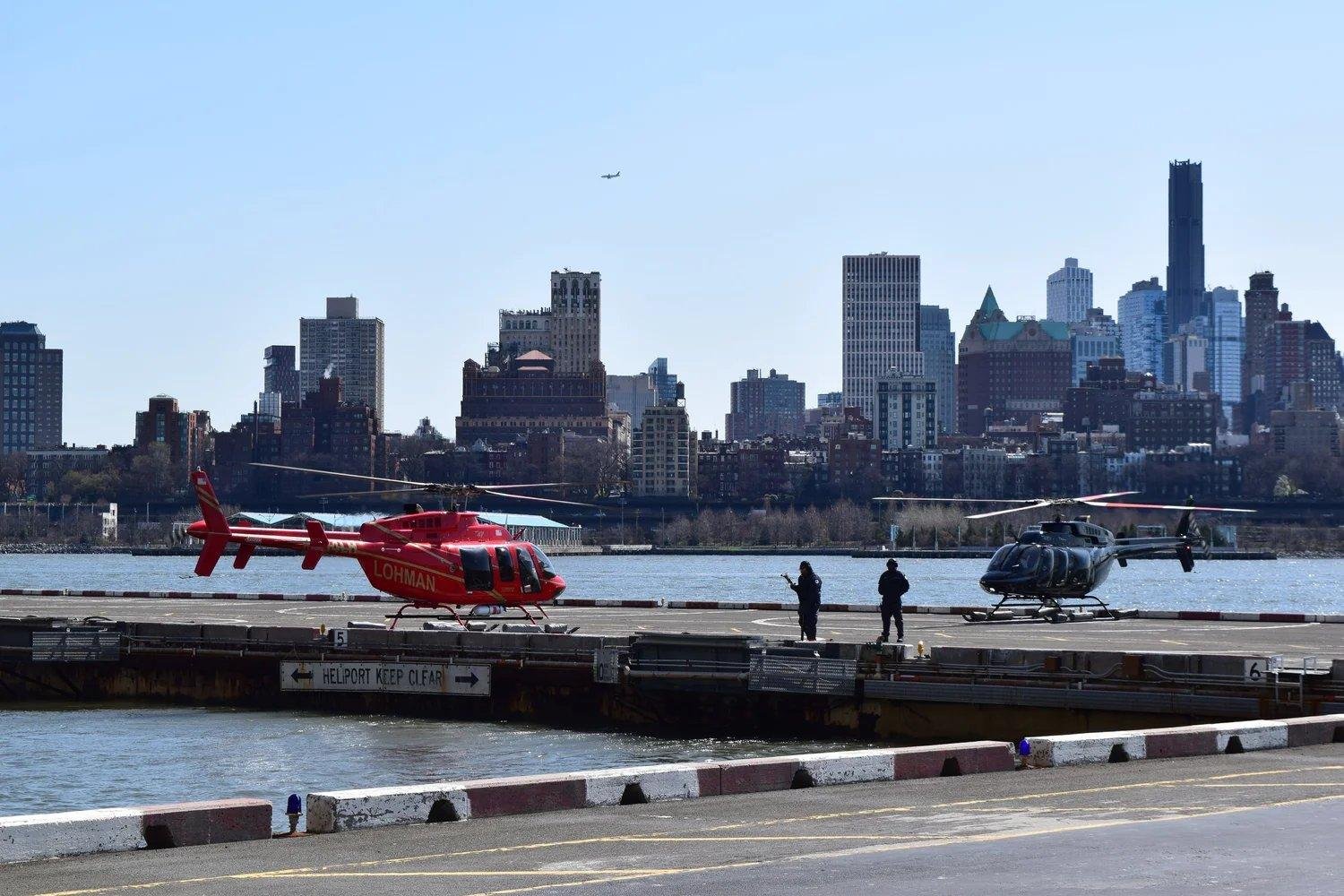 Downtown Manhattan Heliport at Pier 6 with helicopters parked along the East River in New York City