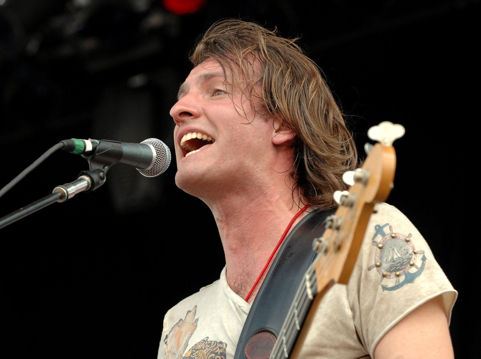 Joe Sumner, frontman of Fiction Plane, performing live with guitar and microphone