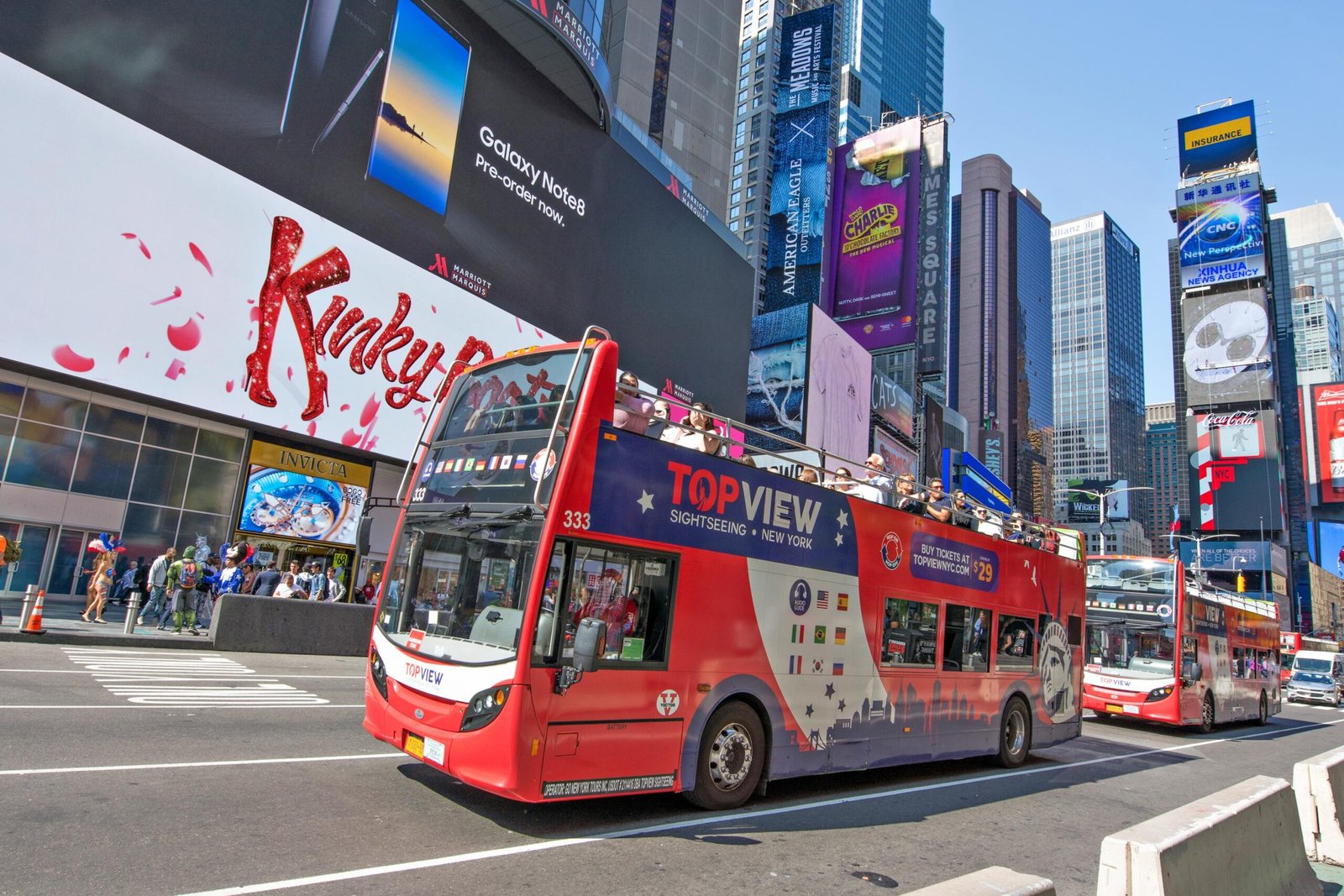 Open-top double-decker sightseeing buses in Times Square, New York City