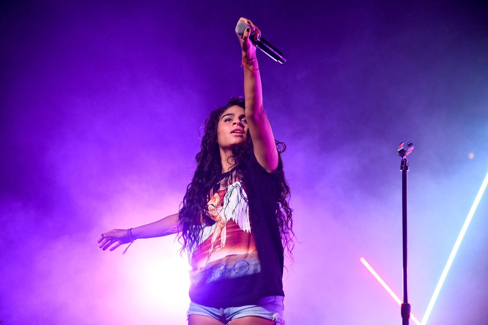 Jessie Reyez performing live on stage during a concert