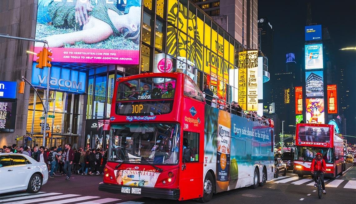 New York City double-decker sightseeing bus offering a nighttime tour of Manhattan