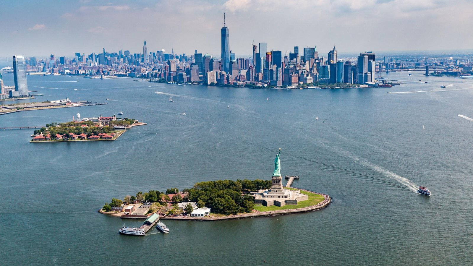 Aerial view of the Manhattan skyline, New York Harbor, Statue of Liberty, and Ellis Island during an NYC helicopter tour