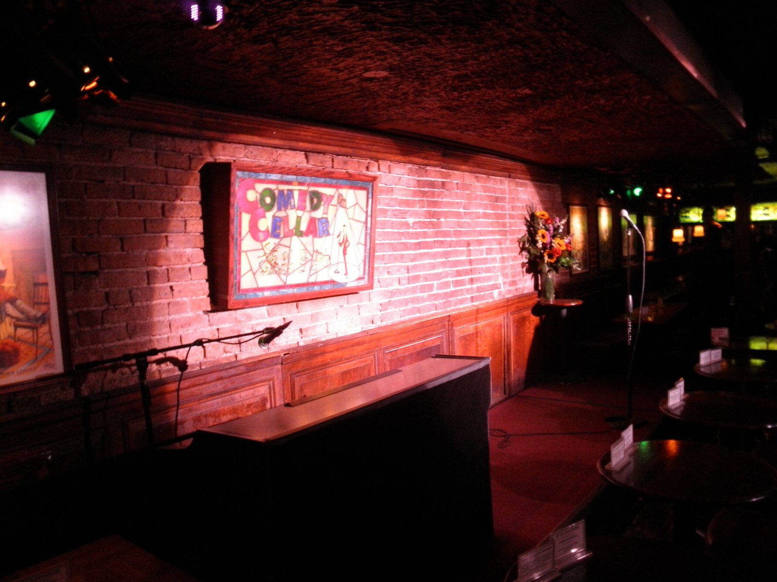 Comedy Cellar stand-up comedy stage in Greenwich Village, New York City, showing the intimate setting of a traditional NYC comedy club