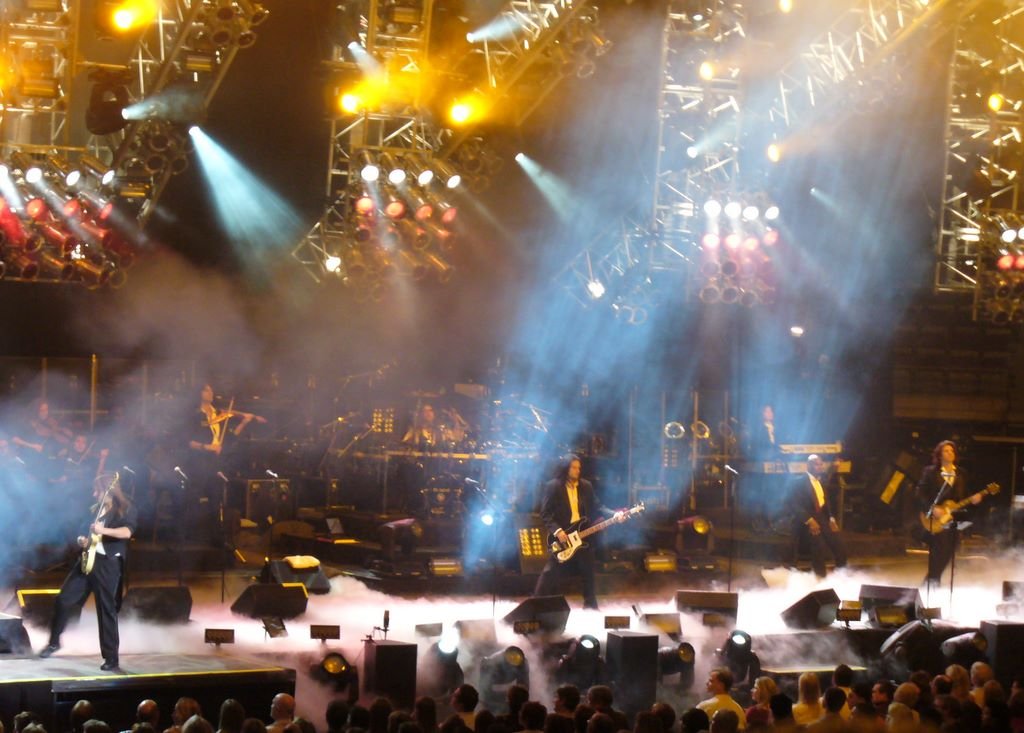 Trans-Siberian Orchestra performing a holiday concert with dramatic stage lighting and rock musicians
